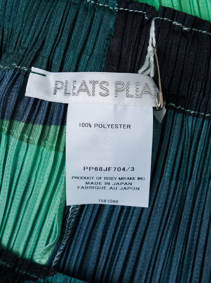 Pleats Please Issey Miyake Orbit wide-leg pleated pants with an abstract green, blue and black colour-block print, shown from the front - view 3