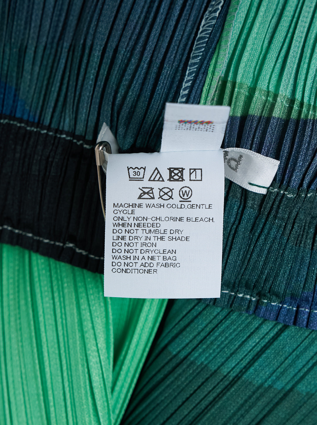 Pleats Please Issey Miyake Orbit wide-leg pleated pants with an abstract green, blue and black colour-block print, shown from the front - view 4