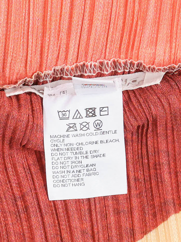 Pleats Please Issey Miyake SURPRISE! midi pencil skirt in permanent micro-pleated fabric featuring an abstract mosaic print in fuchsia, coral, burgundy, sage, and peach - view 3