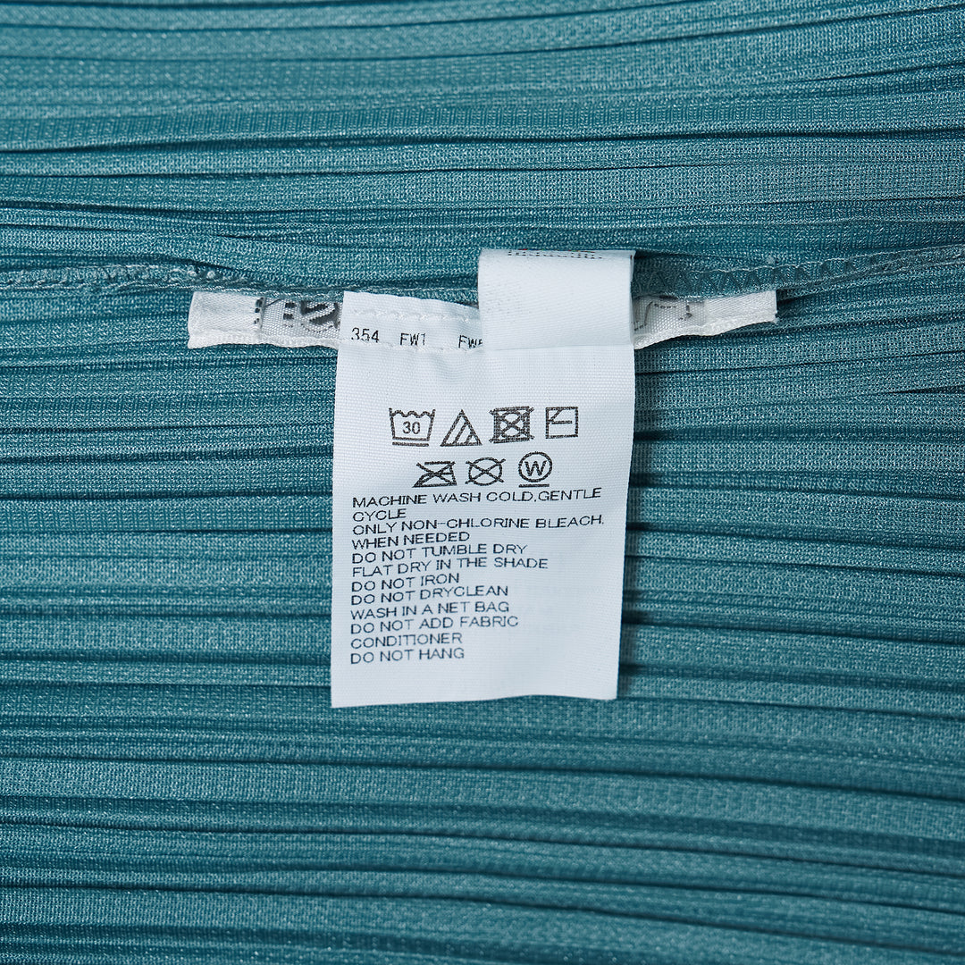Pleats Please Issey Miyake Fold Dress in teal, featuring directionally engineered permanent pleats, sleeveless silhouette, wide square neckline, and asymmetric maxi hem