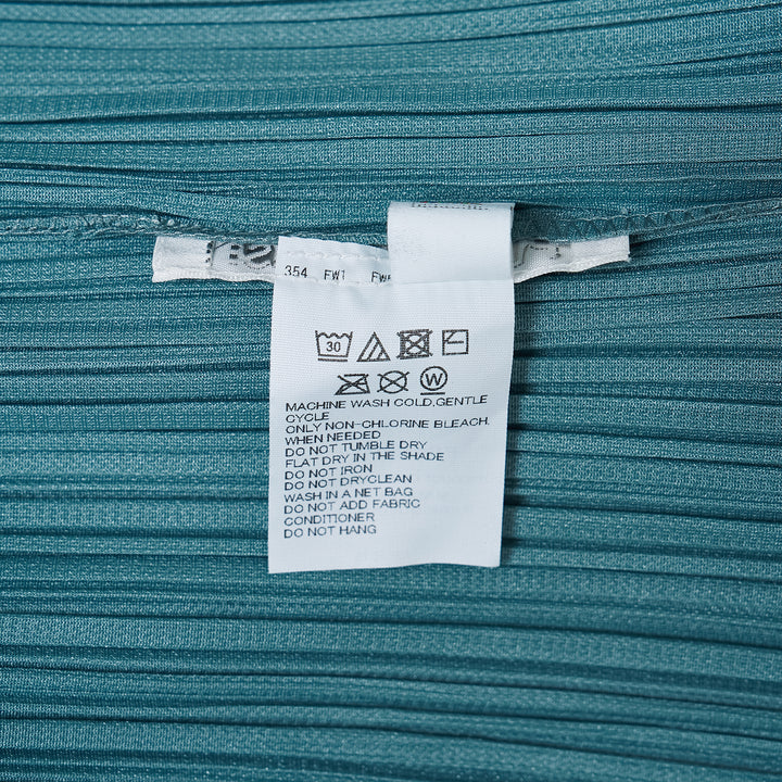 Pleats Please Issey Miyake Fold Dress in teal, featuring directionally engineered permanent pleats, sleeveless silhouette, wide square neckline, and asymmetric maxi hem