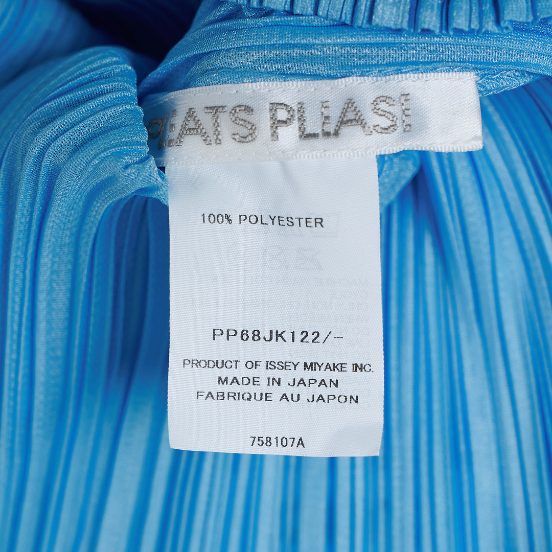 Pleats Please Issey Miyake Monthly Colors August short sleeve top in charcoal grey, featuring all-over permanent pleating, a V-neckline, and a fitted silhouette