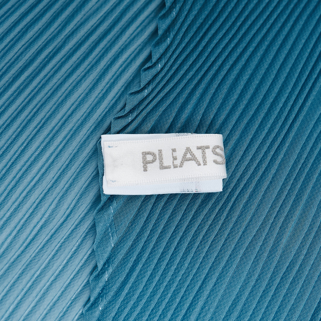 Pleats Please Issey Miyake Monthly Scarf August in charcoal grey, displayed in a folded diamond silhouette showcasing the signature micro-pleated texture