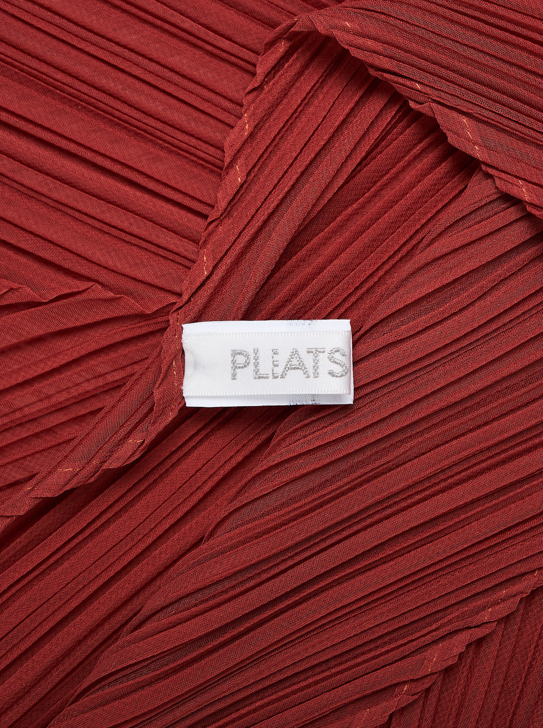 Pleats Please Issey Miyake Monthly Scarf September in deep red, featuring all-over micro-pleating in a chevron pattern and a dramatic zigzag pointed hem - view 2