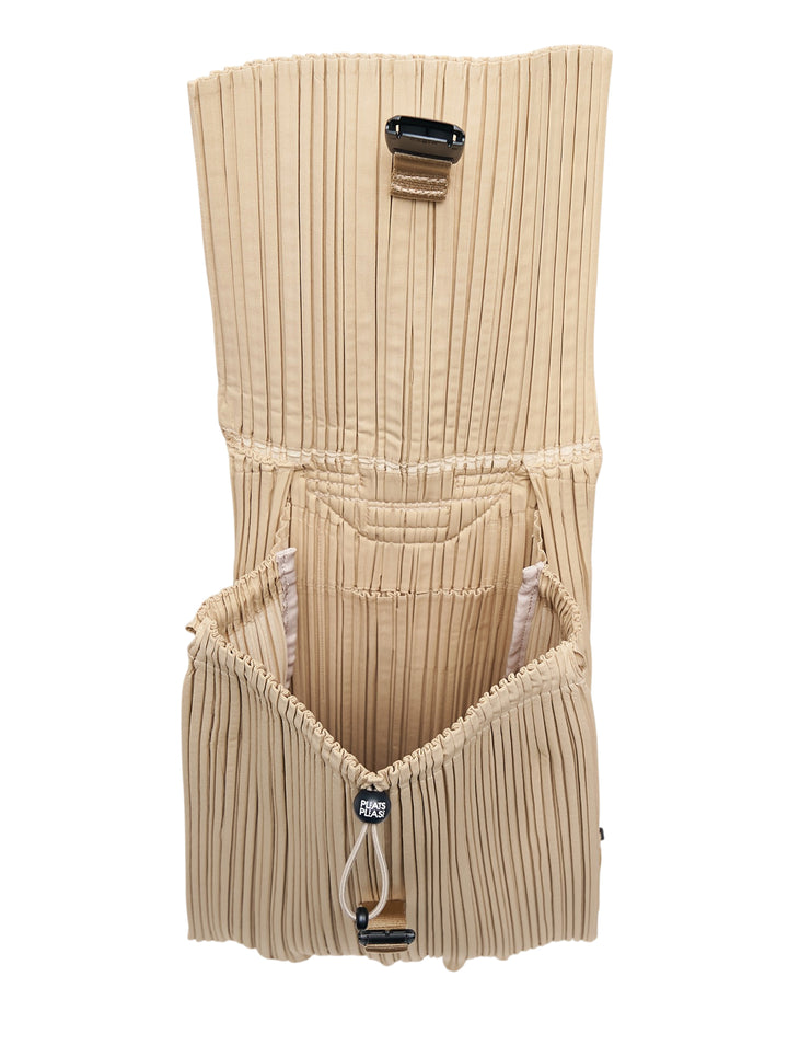 Pleats Please Issey Miyake pleated knapsack in sand beige with flap closure, buckle fastening and top carry handle - view 3