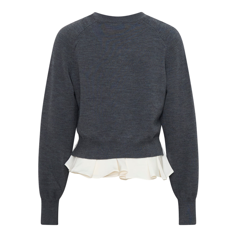 3.1 Phillip Lim Ultrafine Merino Long Sleeve V-Neck Sweater in charcoal grey with a contrast cream woven ruffle hem, front view - view 2
