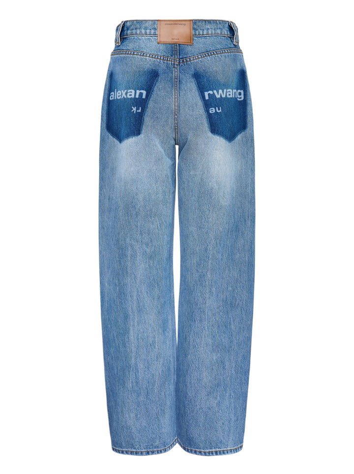 Alexander Wang Float Jeans in washed mid-blue denim with a high rise and curved twisted-seam leg, shown from the front - view 2
