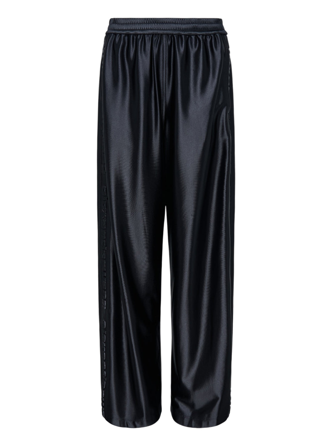 Alexander Wang mid-rise black glossy track pants with embossed side logo panels and elasticated waistband, shown from the front