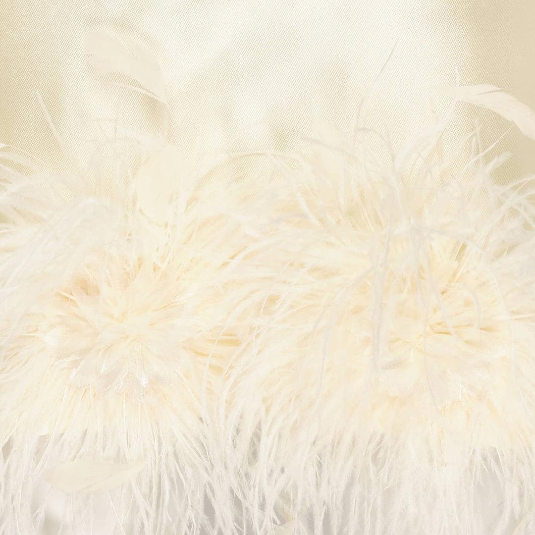 Self-Portrait pale yellow taffeta halter mini dress with feather and floral appliqué trim along the hem, displayed flat on a white background