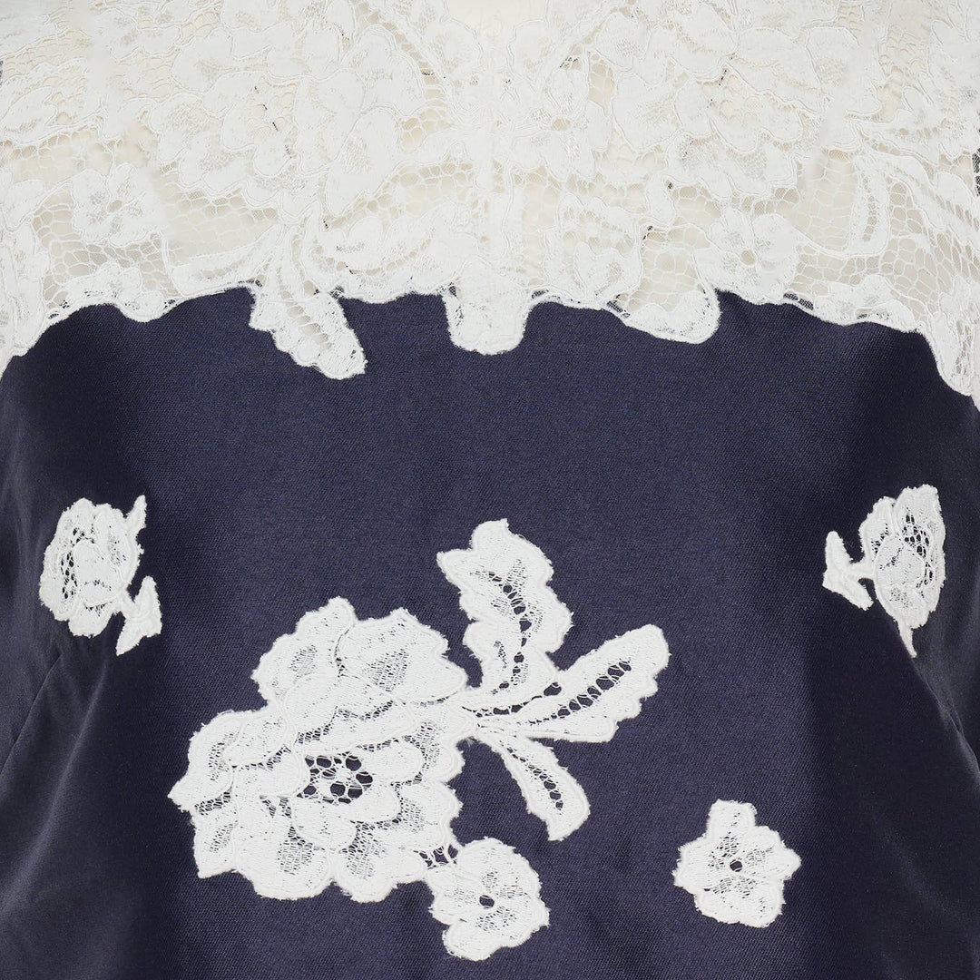 Self-Portrait navy taffeta mini dress with white guipure lace neckline yoke and floral lace appliqué on the front bodice, sleeveless A-line silhouette