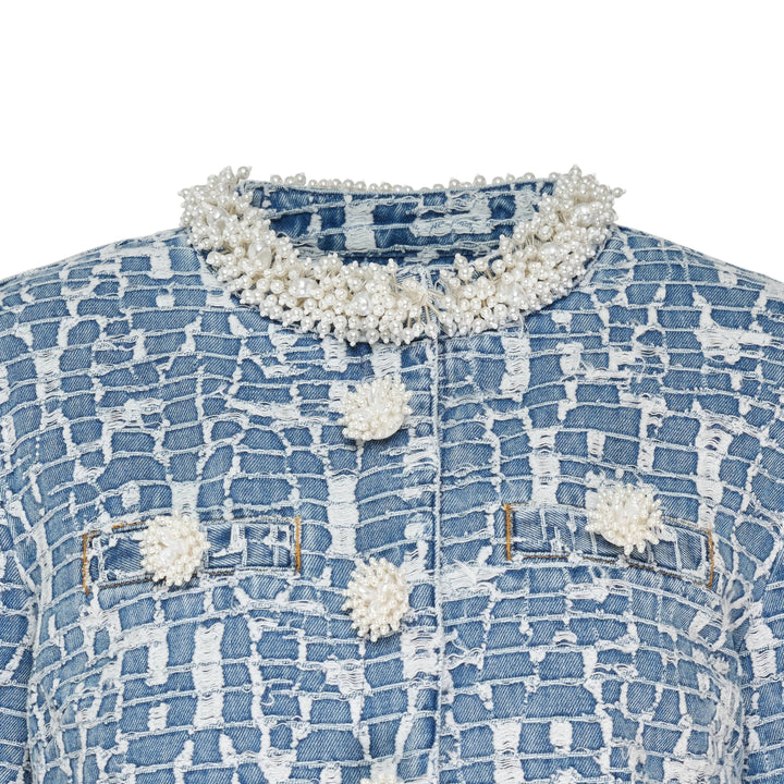 Self-Portrait Blue Textured Denim Jacket with pearl-effect neckline trim, cuff trim, and decorative pearl buttons at centre front, laid flat on a white background