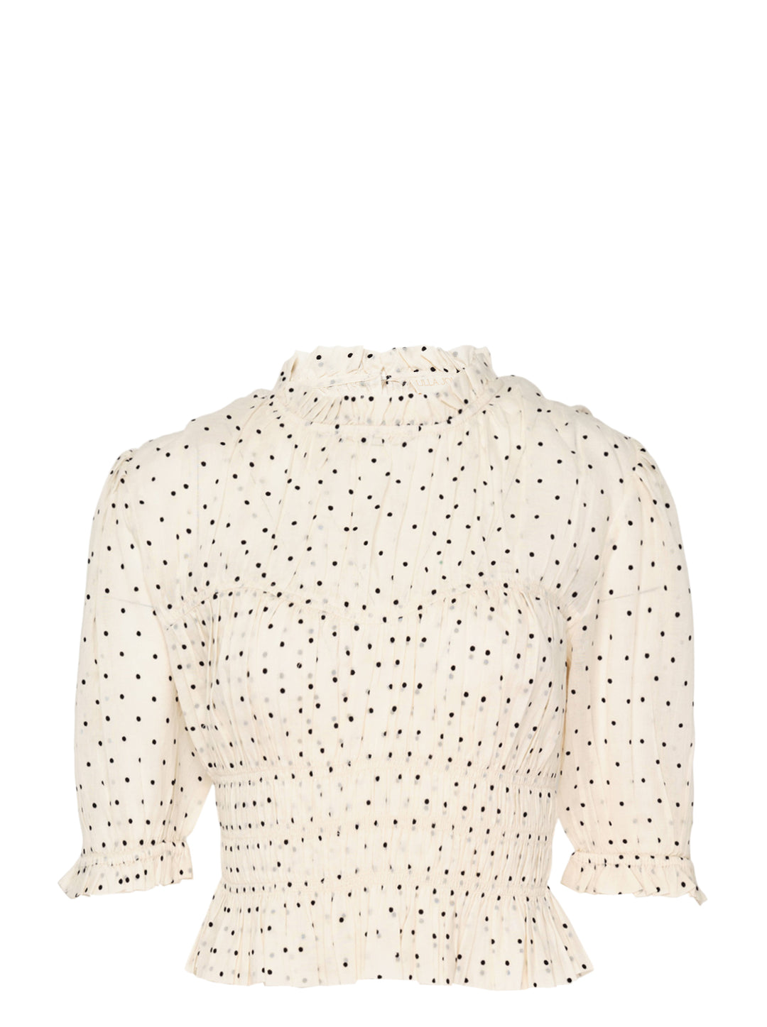 Ulla Johnson Rae short sleeve cotton top in ivory with black polka dots, featuring a ruffled high neckline, puffed sleeves with ruffle cuffs, smocked bodice, and a cropped peplum hem