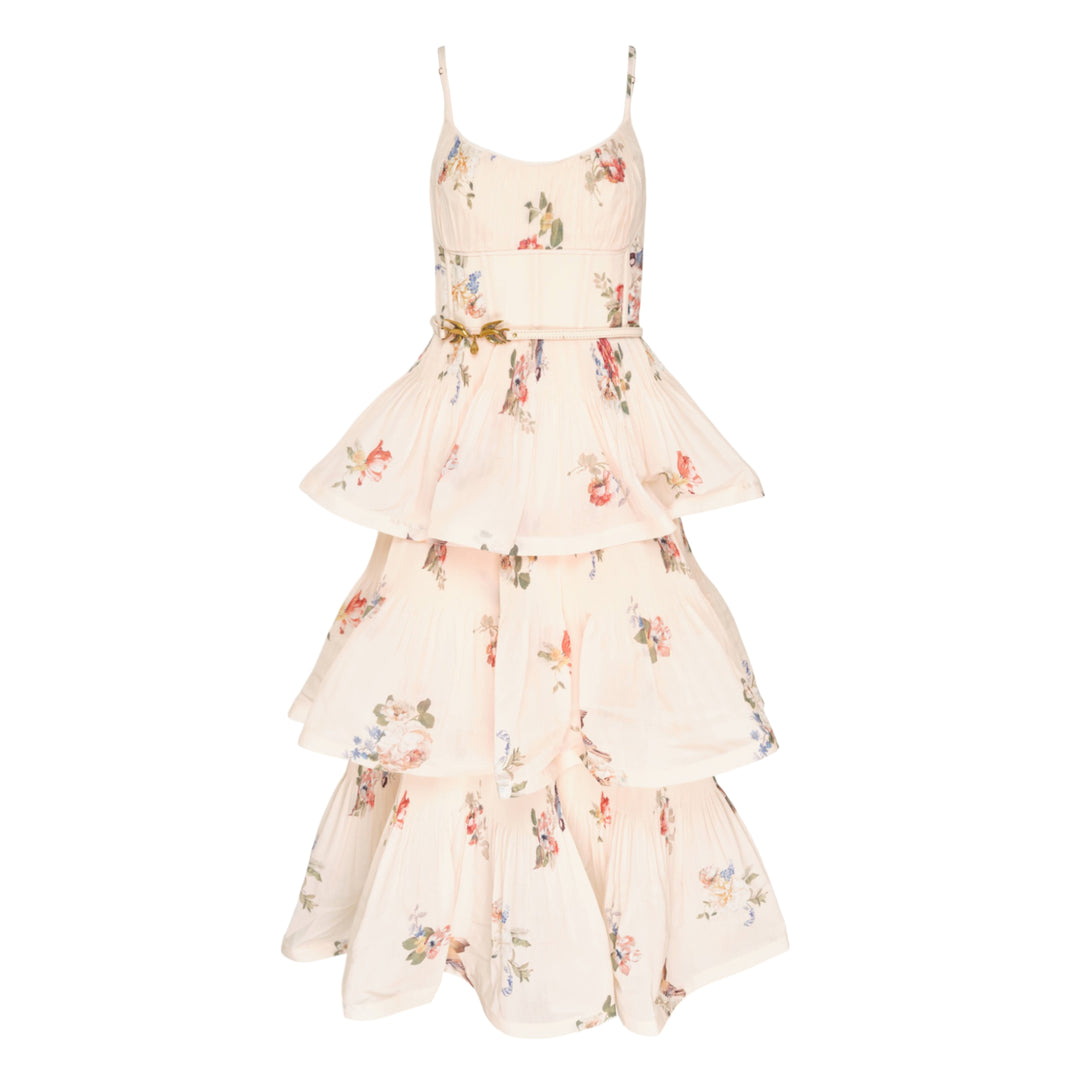 Zimmermann Pleated Tiered Midi Dress in blush floral print, featuring spaghetti straps, a pleated fitted bodice with bow detail, and four cascading ruffle tiers falling to a midi length