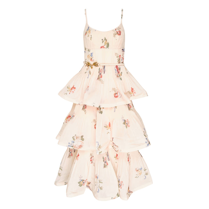 Zimmermann Pleated Tiered Midi Dress in blush floral print, featuring spaghetti straps, a pleated fitted bodice with bow detail, and four cascading ruffle tiers falling to a midi length