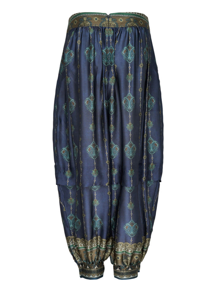 Zimmermann Ascent Harem Pants in navy with teal and gold paisley print, featuring a gathered silhouette, ornate woven waistband, and elasticated ankle cuffs with decorative border trim - view 2