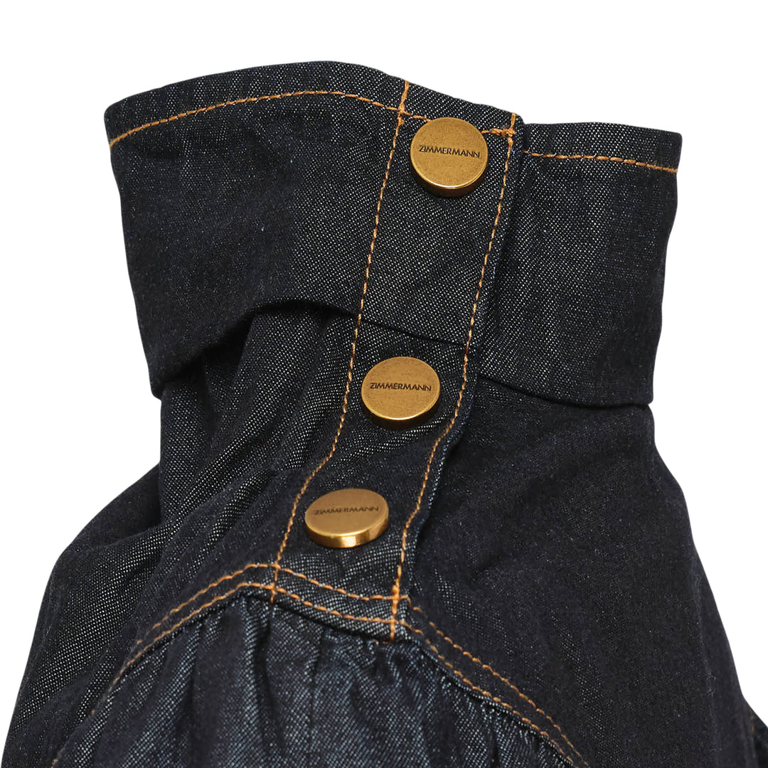 Zimmermann Denim Cape Top in dark indigo, back view, showing V-shaped gathered yoke, amber contrast topstitching, structured collar, and full sweeping hemline