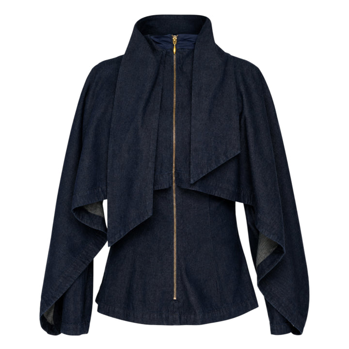 Zimmermann Draped Denim Jacket in dark indigo with cascading chest overlay, voluminous balloon sleeves, and gold-tone centre-front zip, shown on a plain white background