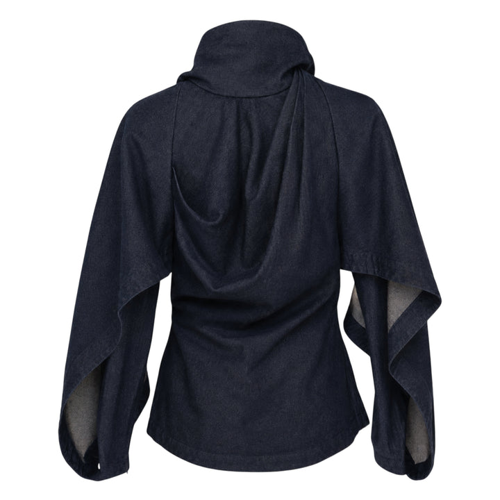 Zimmermann Draped Denim Jacket in dark indigo with cascading chest overlay, voluminous balloon sleeves, and gold-tone centre-front zip, shown on a plain white background