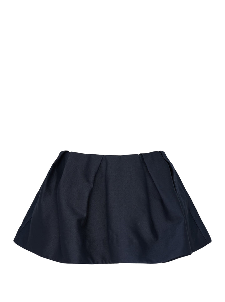SHUSHU/TONG Pleated Mini Skirt in deep navy, featuring a fitted waistband, front pleat, and full voluminous flared hem, shown flat on a white background