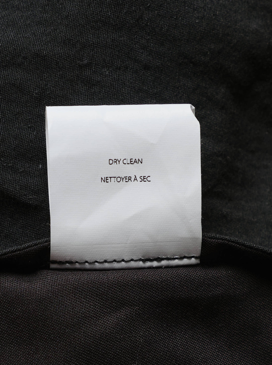 Lauren Manoogian black pleated taper trousers with a high waist and curved leg, shown from the front - view 3