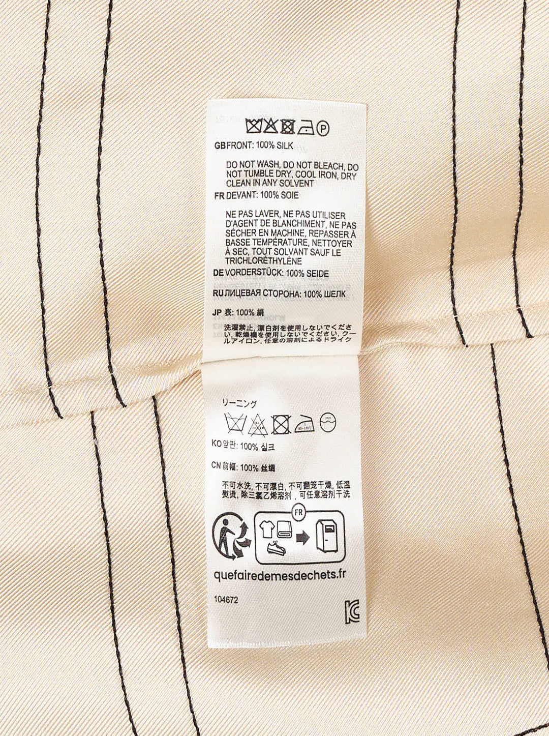 Totême Monogram Silk Pyjama Pants in champagne beige, featuring an all-over geometric monogram outline print, wide-leg silhouette, and elasticated waistband, displayed flat on a white background - view 3