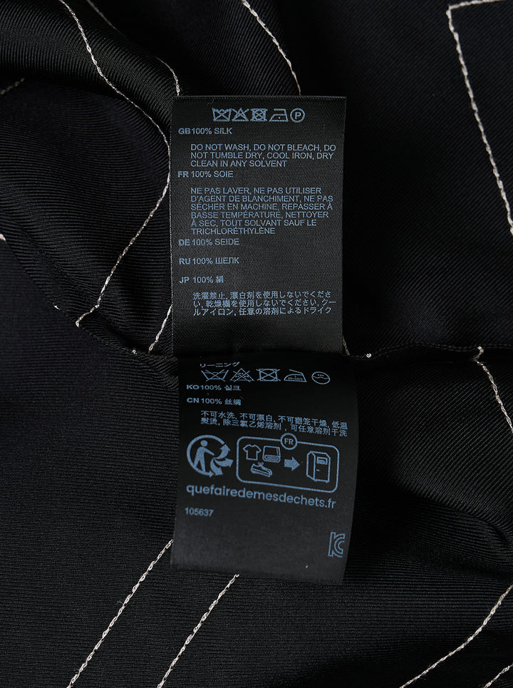 Totême Monogram Silk Pyjama Top in black, featuring all-over contrast-stitched monogram print, camp collar, partial button placket, and relaxed long-sleeve silhouette - view 3