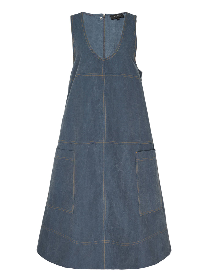 Lee Matthews Cecil Cotton Apron Dress in washed blue denim, featuring a V-neckline, A-line silhouette, contrast topstitching, and two front patch pockets