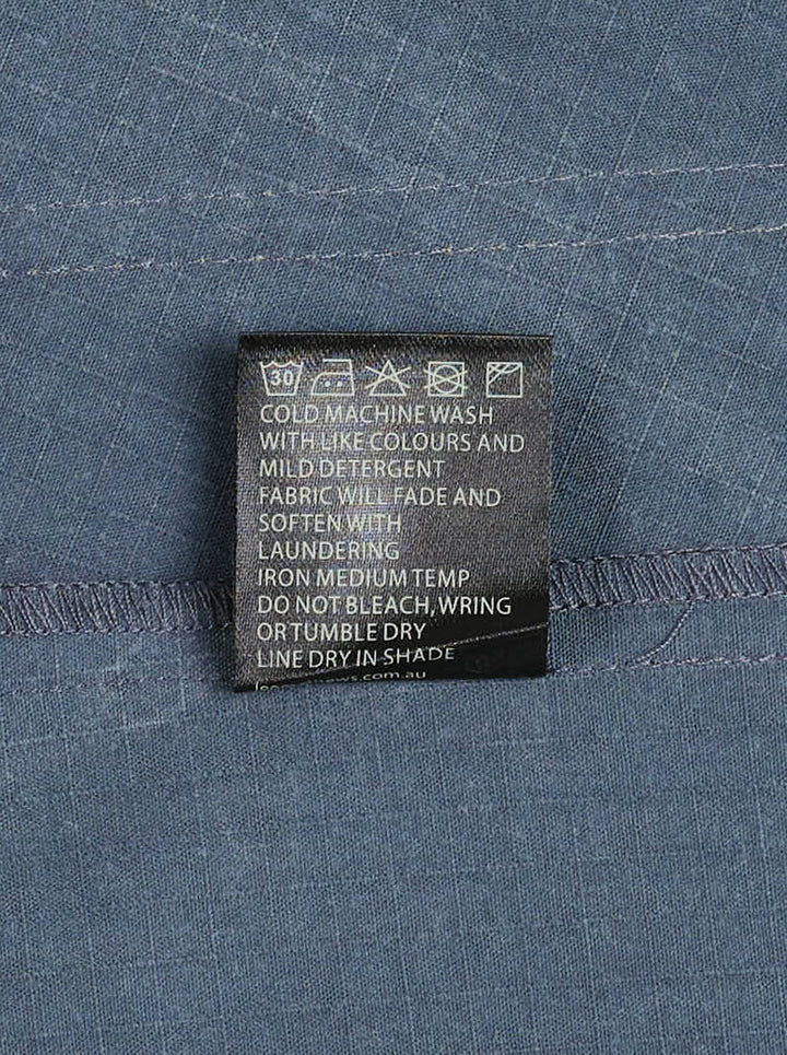 Lee Matthews Cecil Cotton Apron Dress in washed blue denim, featuring a V-neckline, A-line silhouette, contrast topstitching, and two front patch pockets - view 3
