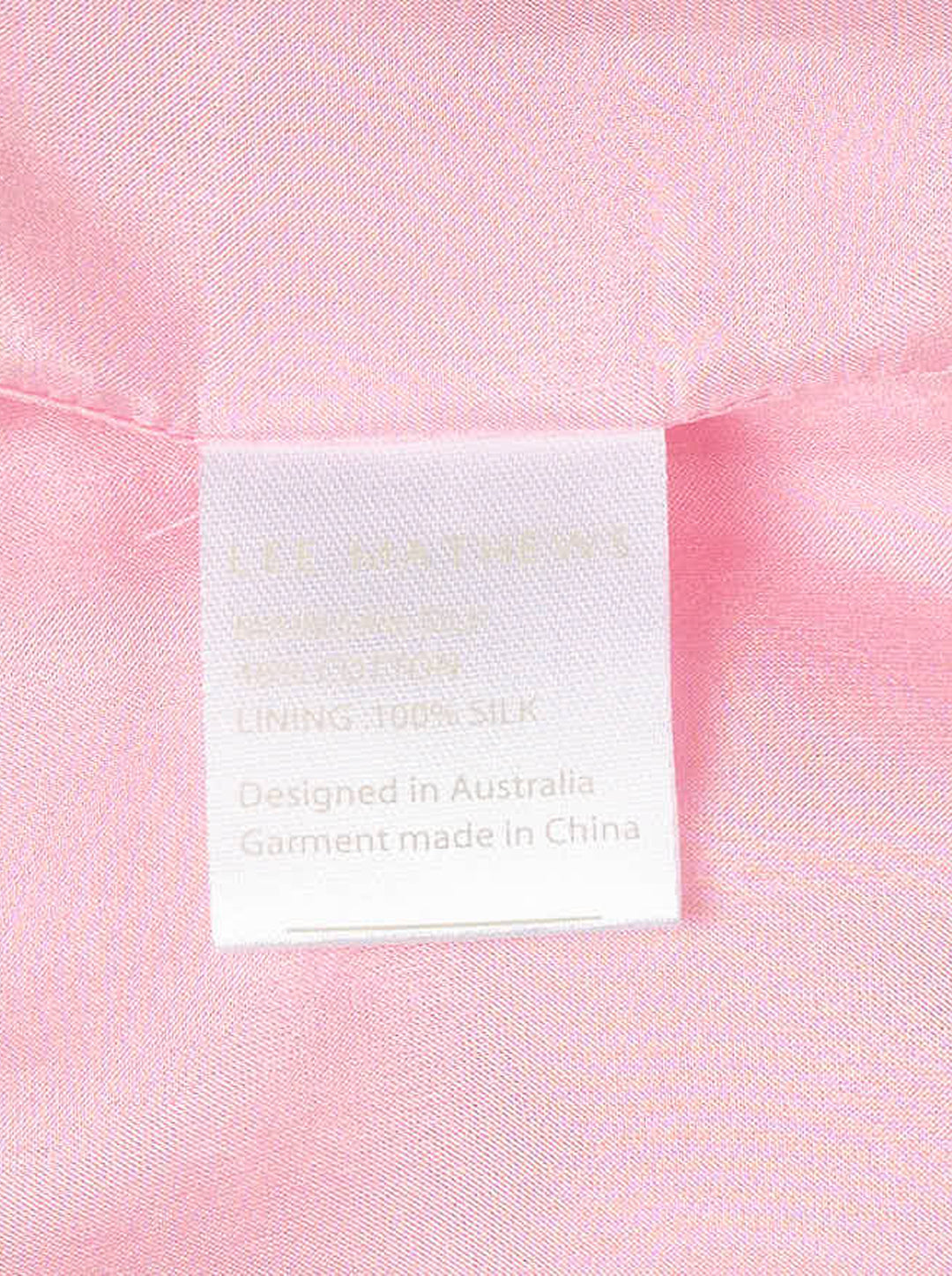 Lee Mathews Nina Silk Ruffle Dress in blush pink — sleeveless midi with panelled construction and a pleated ruffle hem, shown on a white background - view 3