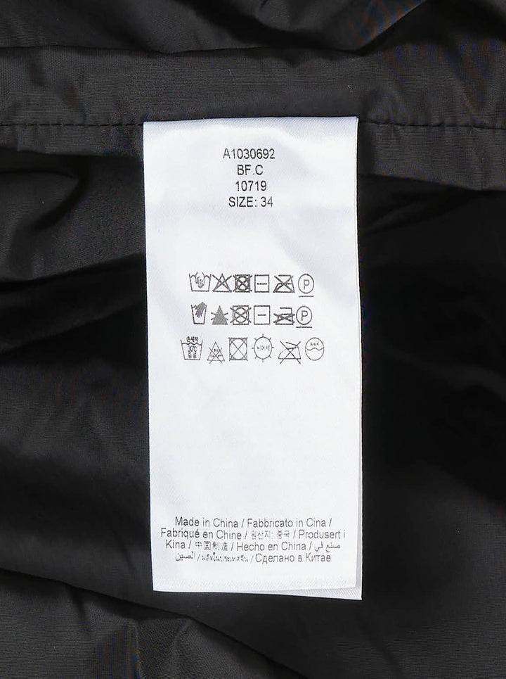 Ganni Flyweight Nylon Mini Utility Dress in black, featuring a camp collar, tonal snap button placket, oversized chest cargo pockets, and a gathered tiered flared skirt - view 4
