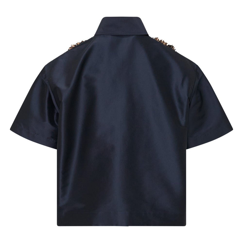 Biyan navy taffeta short sleeve shirt with sculptural black beaded and sequined floral embellishment across the chest and shoulders, displayed on a white background - view 2