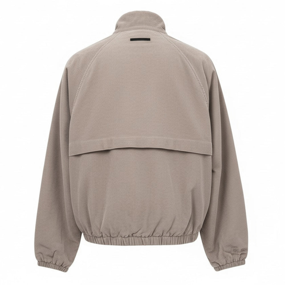 Fear of God Essentials Modern Filled Blouson Jacket in taupe, featuring a full-length zip, stand collar, raglan sleeves, and elasticated hem and cuffs, shown flat on a white background - view 2