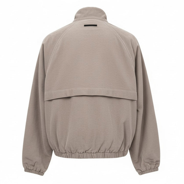 Fear of God Essentials Modern Filled Blouson Jacket in taupe, featuring a full-length zip, stand collar, raglan sleeves, and elasticated hem and cuffs, shown flat on a white background - view 2