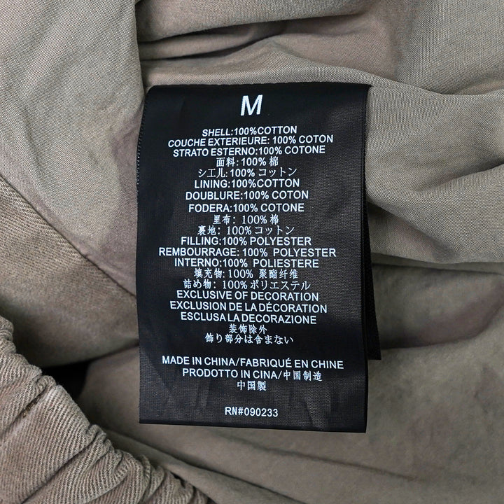 Fear of God Essentials Modern Filled Blouson Jacket in taupe, featuring a full-length zip, stand collar, raglan sleeves, and elasticated hem and cuffs, shown flat on a white background - view 3
