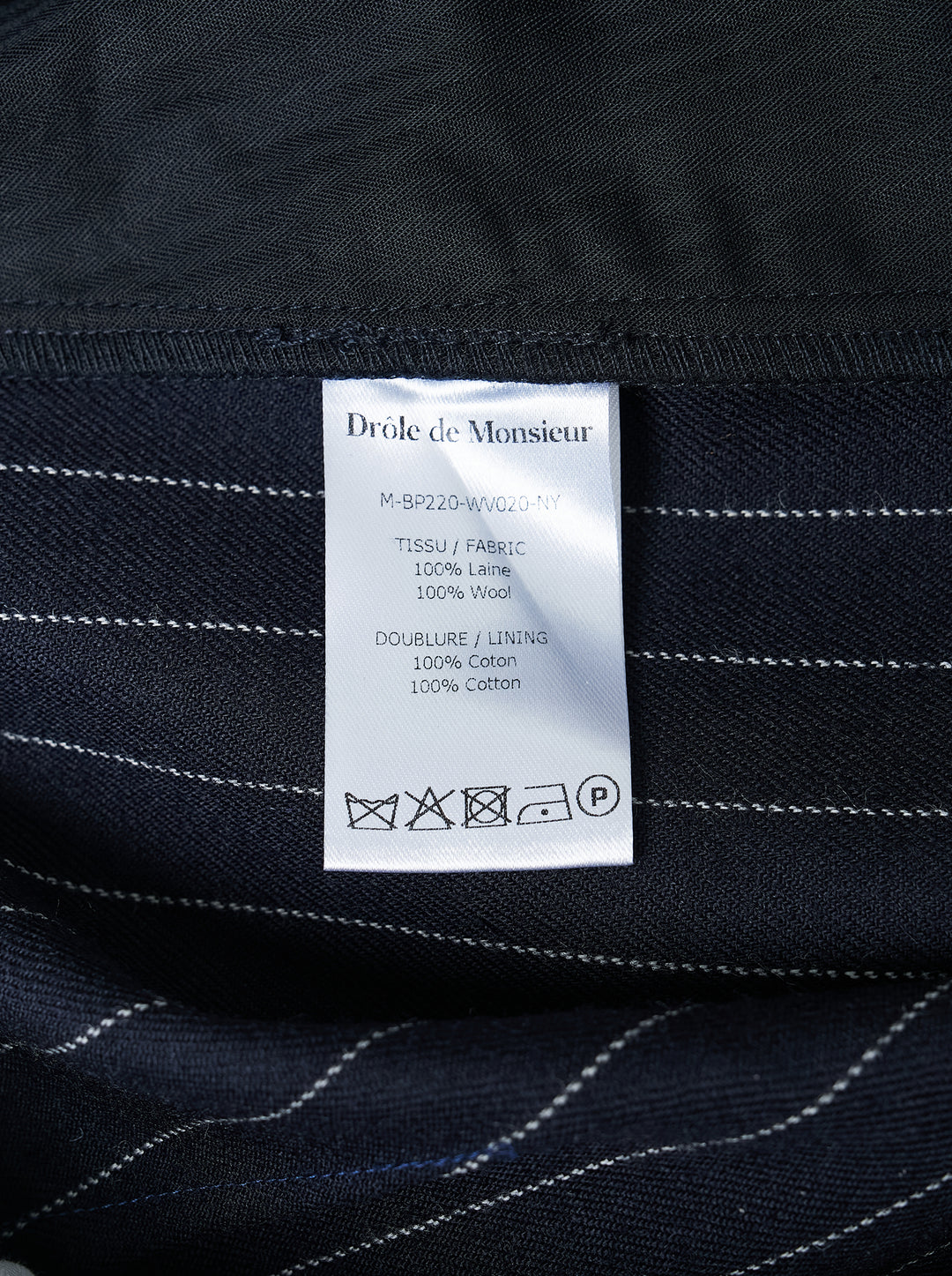 Navy pinstripe single pleat trousers by Drôle de Monsieur, shown front-facing with high waist and tapered leg - view 3