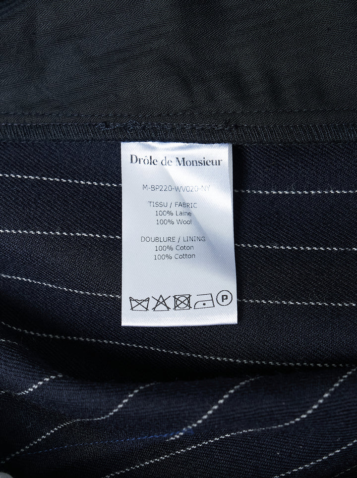 Navy pinstripe single pleat trousers by Drôle de Monsieur, shown front-facing with high waist and tapered leg - view 3