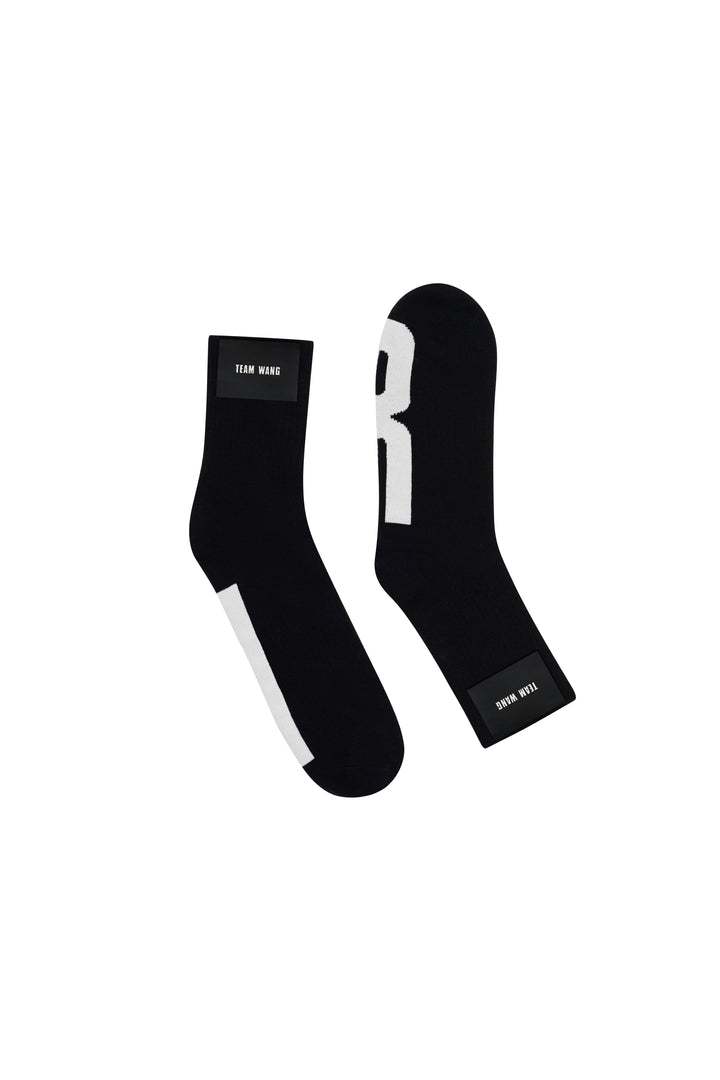 TEAM WANG design Original 1 Crew Socks in black with contrast white heel and woven brand label at the cuff, shown as a pair on a white background - view 2