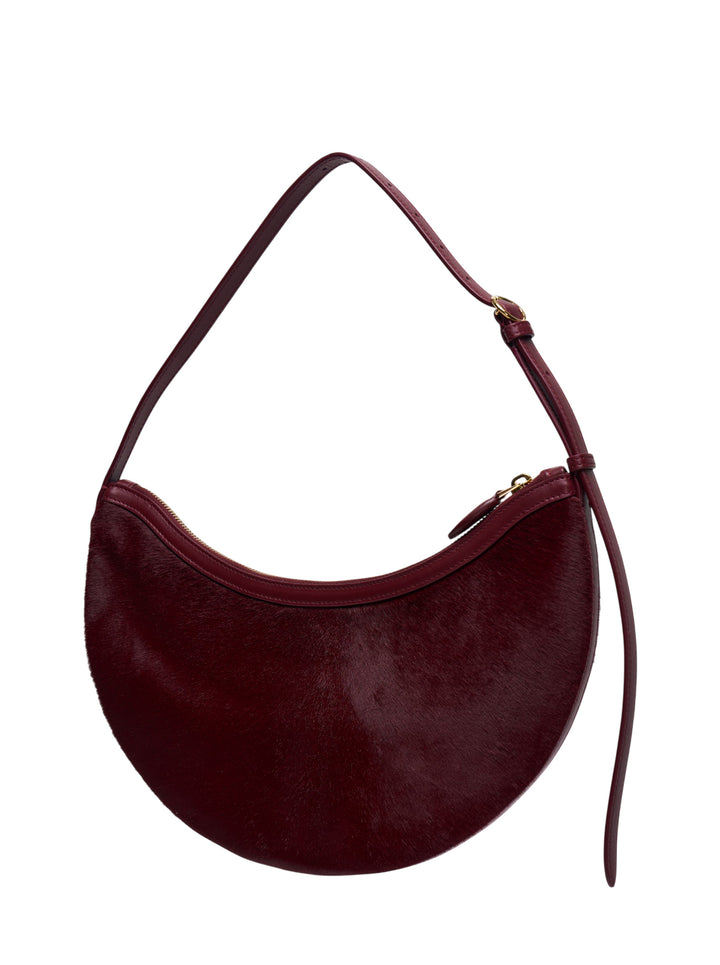 Alaïa Demi Lune haircalf crescent shoulder bag in deep burgundy with smooth leather trim and gold-tone zip closure - view 2