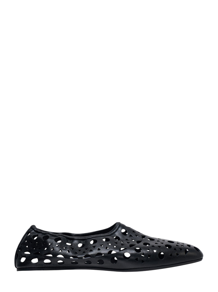 Alaïa Neo Vienne black nappa lambskin flat shoe with all-over laser-cut perforations and a rounded square toe, shown in profile view