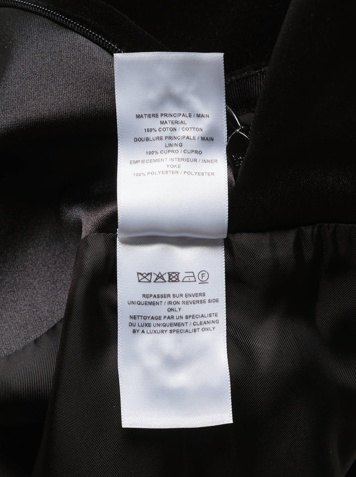 Alaïa black cotton velvet column maxi skirt with structured wide waistband, hip patch pockets, and a subtle flare at the hem, shown on a white background - view 3