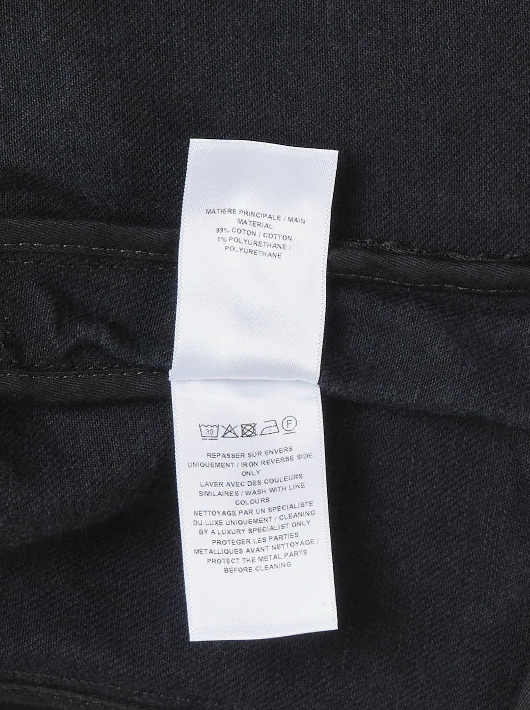 Alaïa Black Denim Biker Jacket with asymmetric silver-tone zip, corset seaming, and cropped curved hem, shown flat on white background - view 3