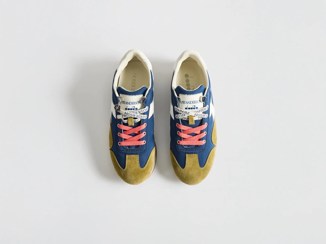 Diadora x JW Anderson retro nylon sneaker in blue with khaki suede overlays, coral laces, and a white Diadora logo stripe, set against a white background - view 4
