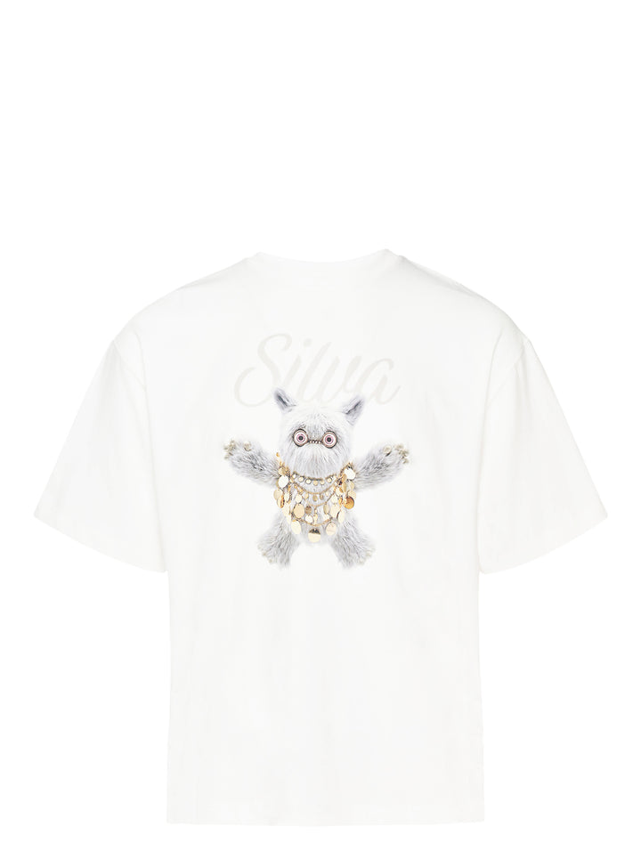 Back view of The Fluffadoos Silva Name Story Tee in white, featuring a large printed graphic of a fluffy grey creature wearing gold coin jewellery with 'Silva' script lettering above
