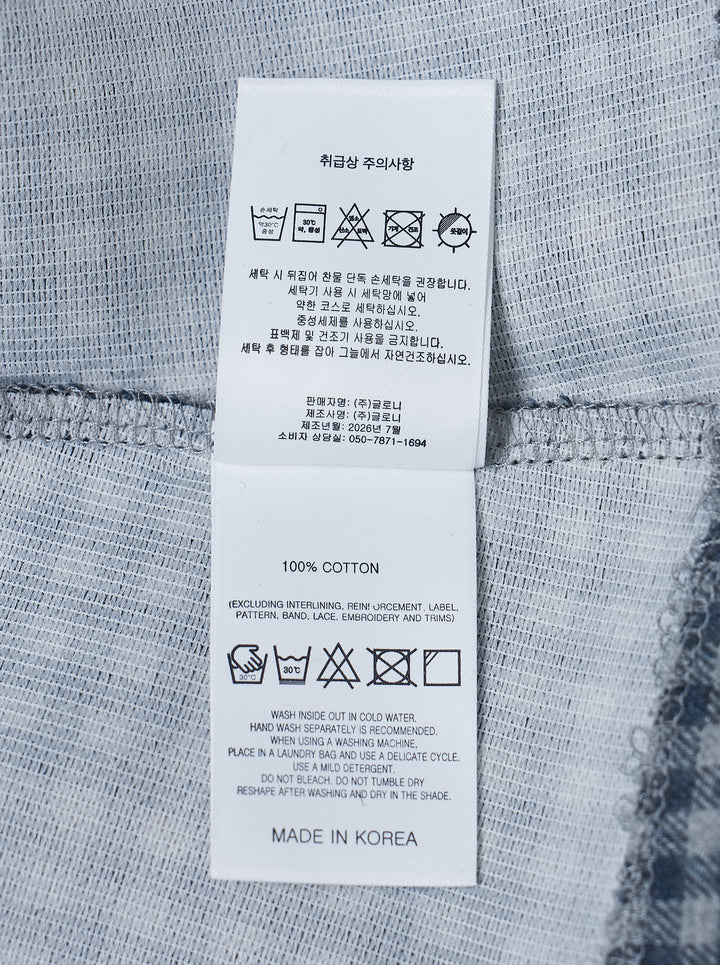 Glowny Polly Wrap Skorts in navy and white gingham check, showing structured waistband with button fastening and welt back pocket, laid flat on white background - view 3