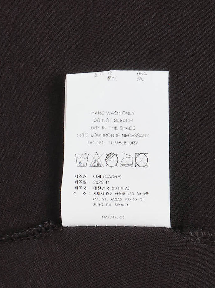 Black Nache slim fit long sleeve top with scoop neckline, flared cuffs and a distorted white typographic graphic reading 'For me, memory were the present' - view 3
