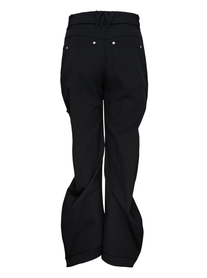 Nache Rawcut Curved Pants in black, featuring a sculpted bowed leg, raw-cut waistband, metal button closure and rivet details, shown from the front - view 2