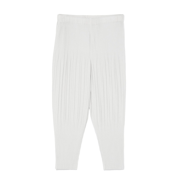 Homme Plissé Issey Miyake Fluffy Pleated Pants in off-white with all-over vertical pleating and elasticated waist, laid flat on white background