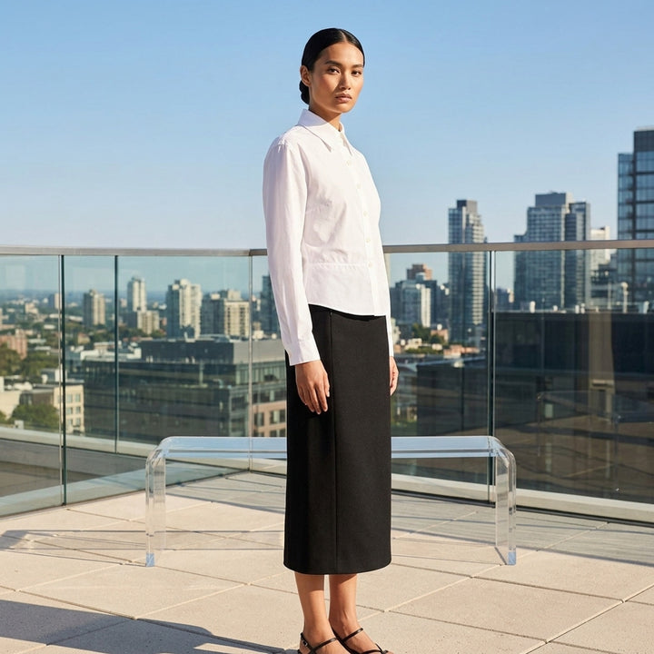 Alaïa Basque Cotton Poplin Shirt in white, featuring a sculpted waist seam, peplum hem, point collar, and mother-of-pearl button front fastening - lifestyle