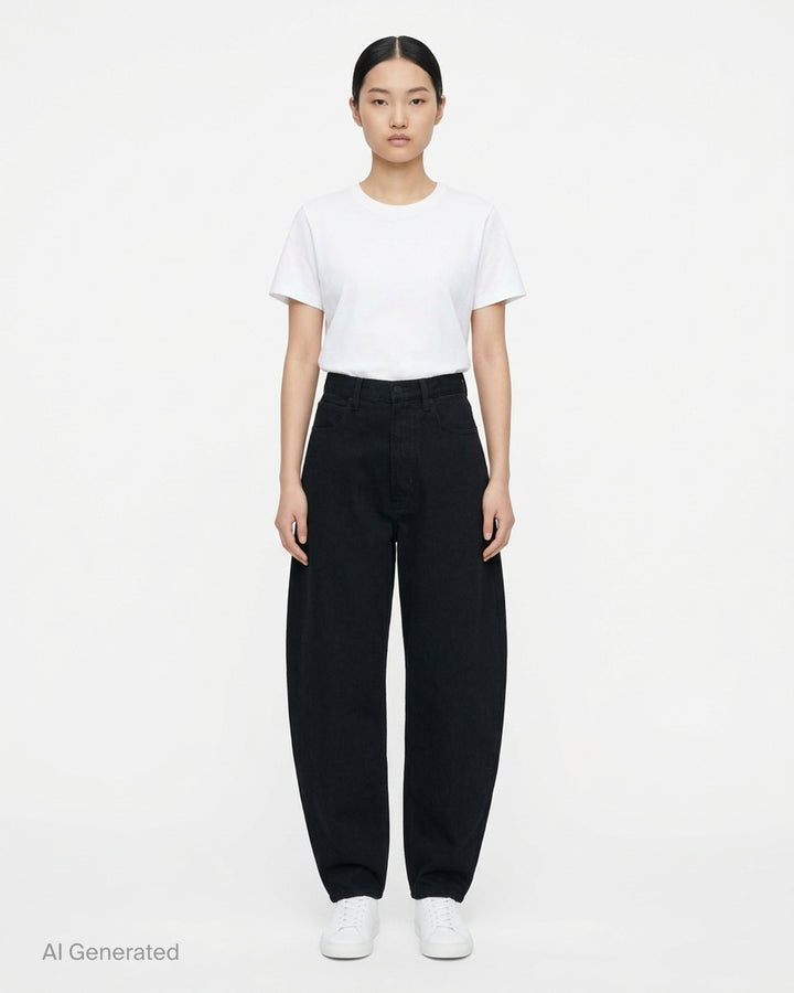 Alaïa black denim round pants with a high waist, five-pocket design and sculpted curved leg, shown from the front - front