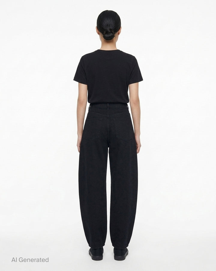 Alaïa round black denim jeans with a high waist and sculpted curved leg, shown front view - back